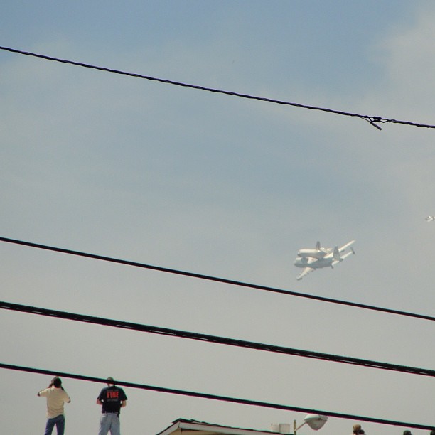People on the roof of the Warner lot watching the shuttle.